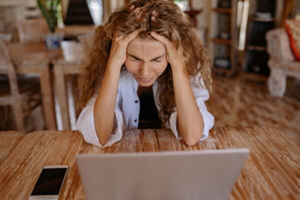 Frustrated woman sitting in front of laptop